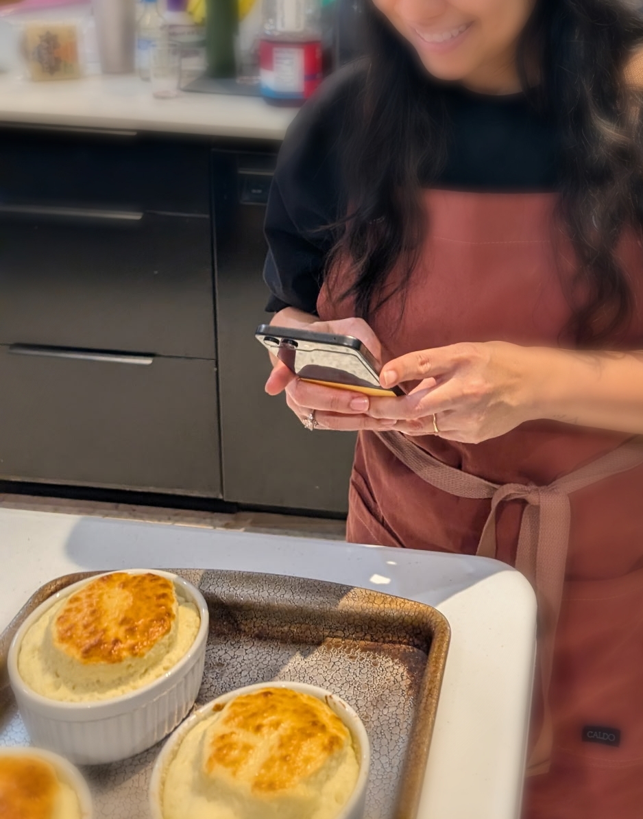 A home cook photographing the soufflés she just baked