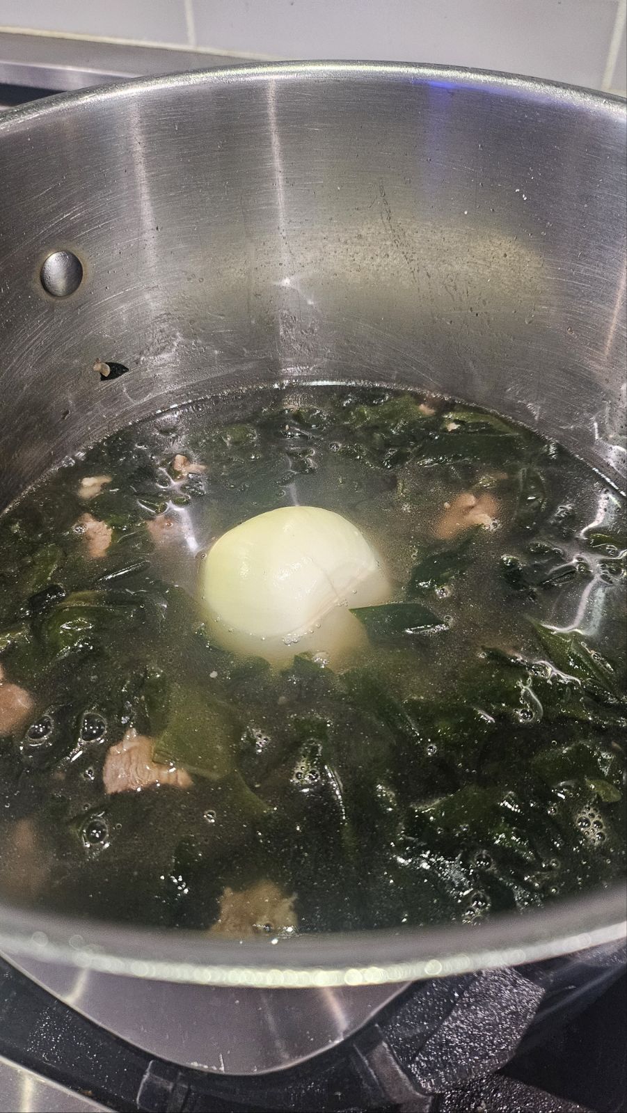 Adding water and onion to the broth